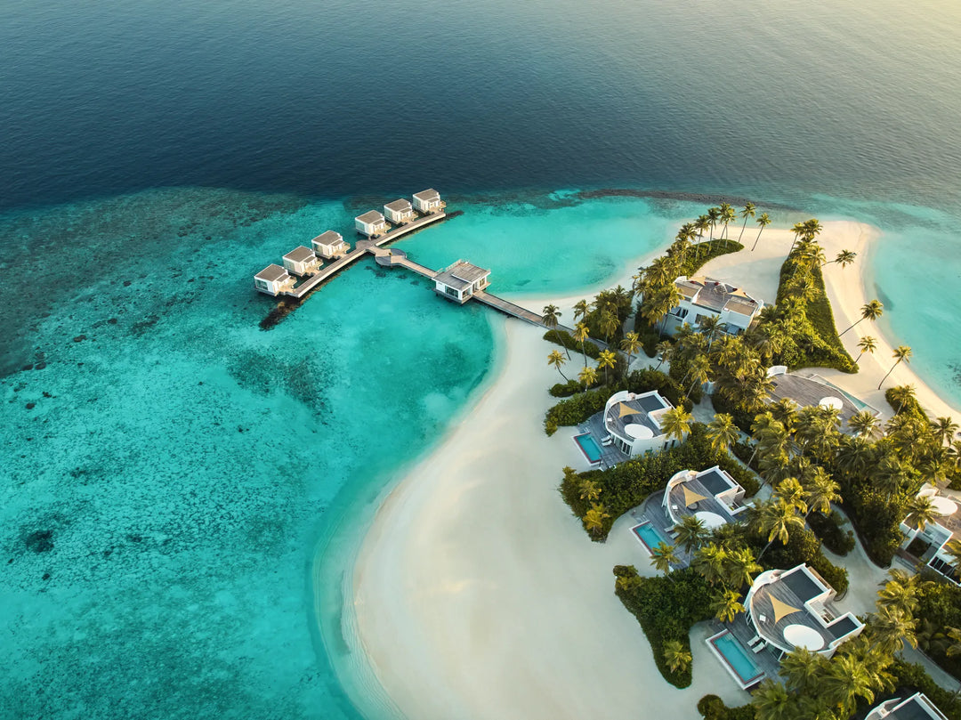 Resort on an island with blue water and white sand