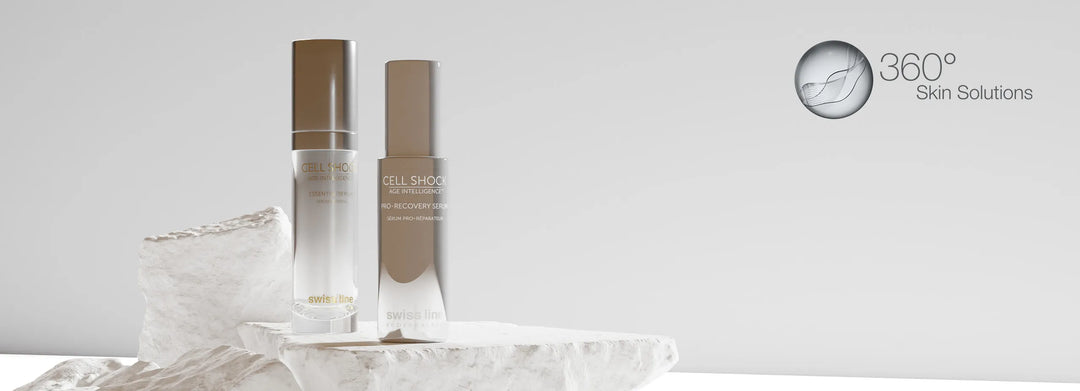 Two Swissline products, Pro-Recovery Serum, and Essential Serum , on a white rock