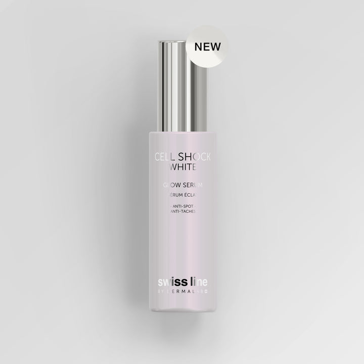 A bottle of Swiss Line Cellular Glow Serum in 'Cell Shock White' with a silver cap and a white 'NEW' sticker, set against a clean light gray background.